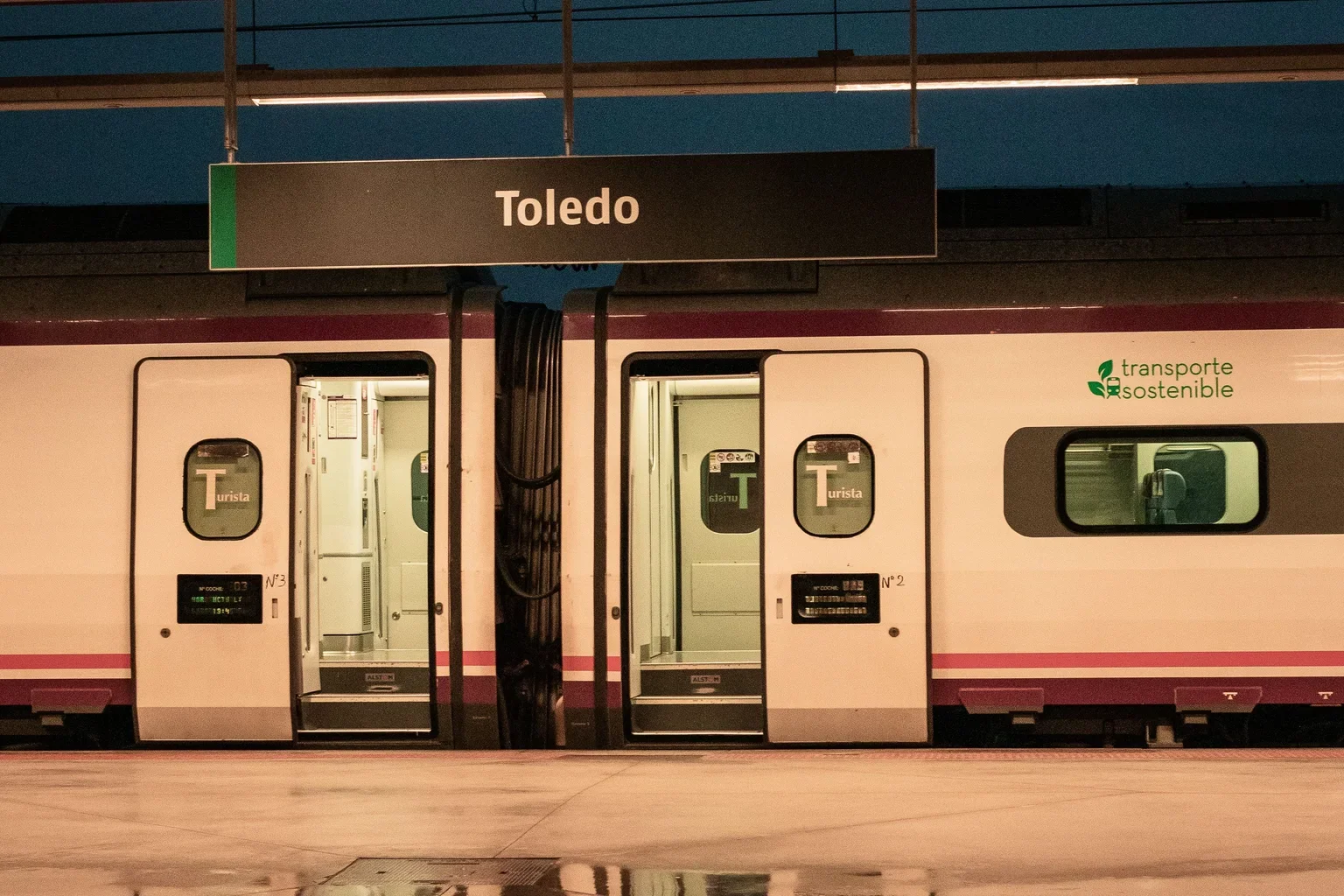A train beside the platform at Toledo station at night.