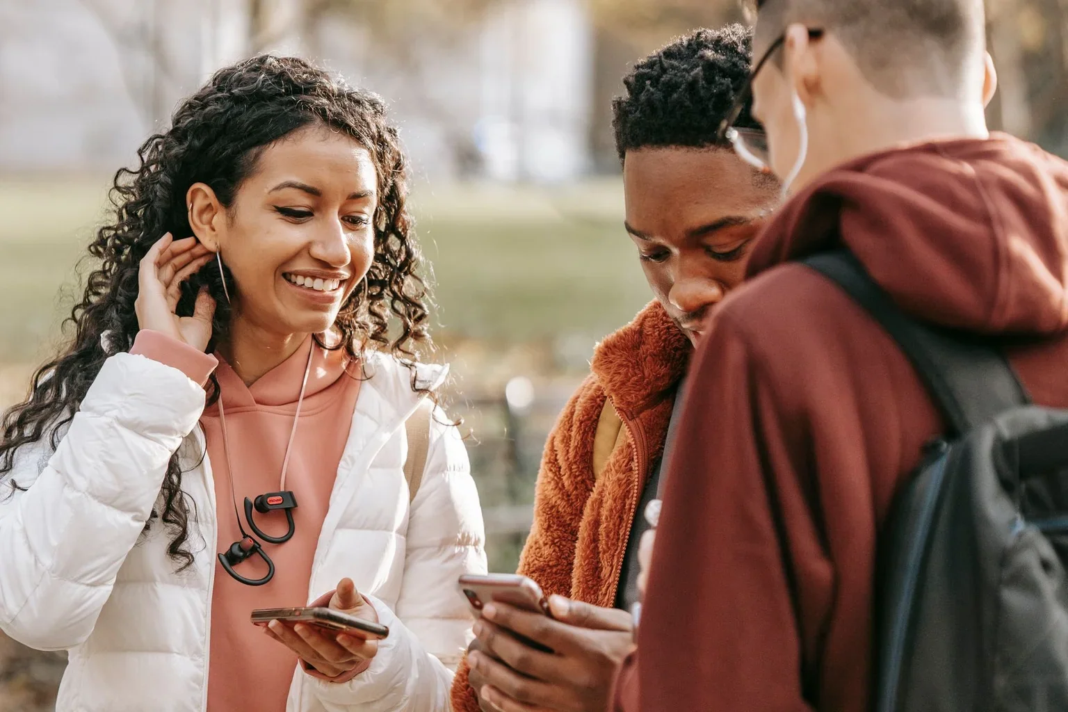 Friends looking at a smartphone while outdoors
