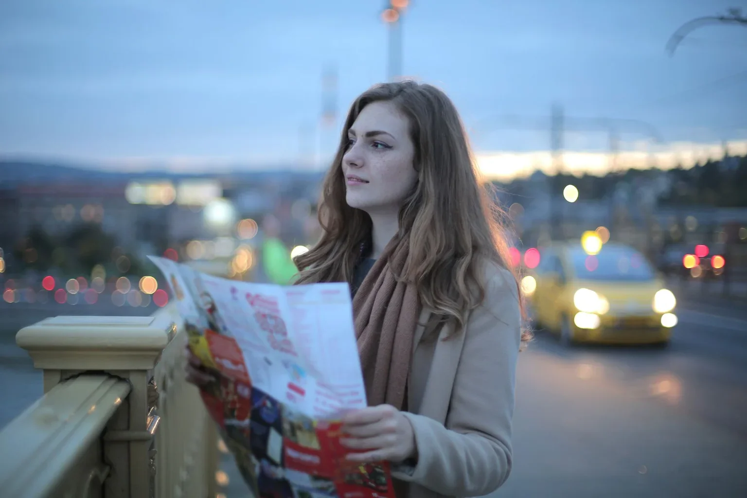 A traveller looking up from a map to check the street