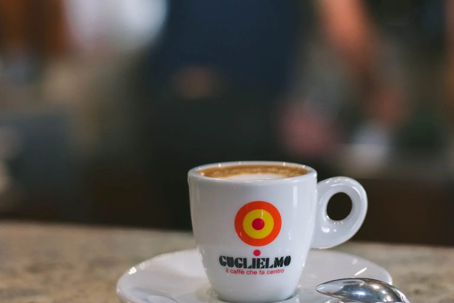 An espresso cup and saucer on a café counter