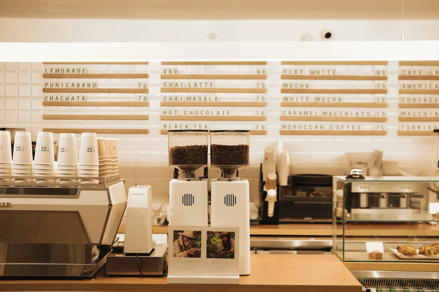 Coffee equipment and cups arranged behind a café counter